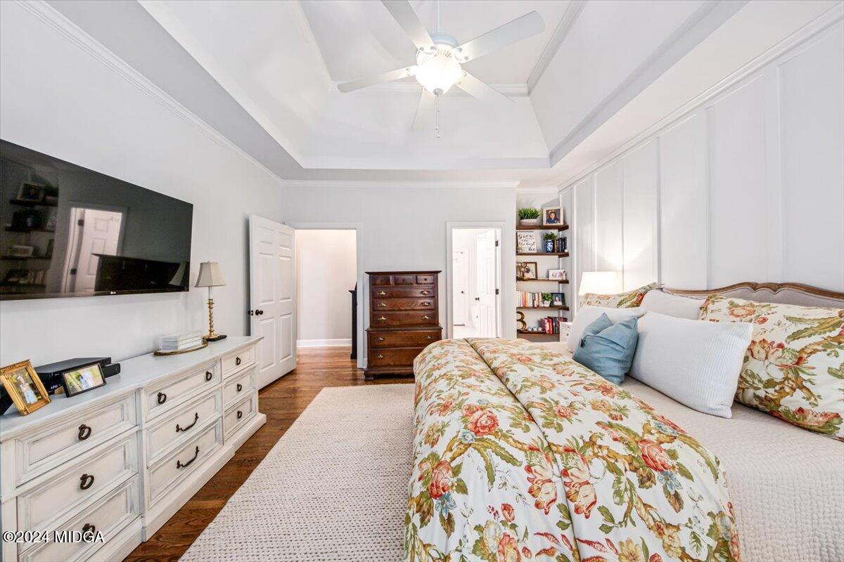 7701 Whittle Road Macon, GA 31220 - Photo 25 of 56 a bedroom with a large bed and a flat tv screen