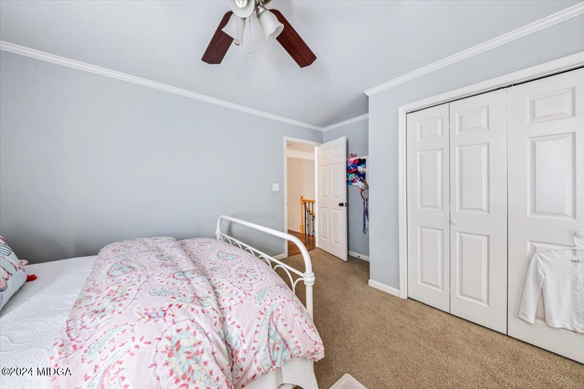 7701 Whittle Road Macon, GA 31220 - Photo 32 of 56 a bedroom with a bed and cabinets