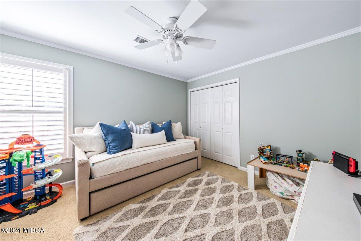 7701 Whittle Road Macon, GA 31220 - Photo 34 of 56 a spacious bedroom with a bed and a window