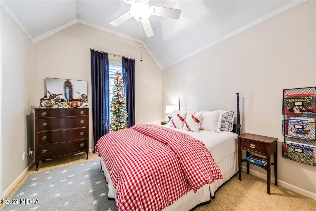 7701 Whittle Road Macon, GA 31220 - Photo 38 of 56 a bedroom with a bed and a chandelier