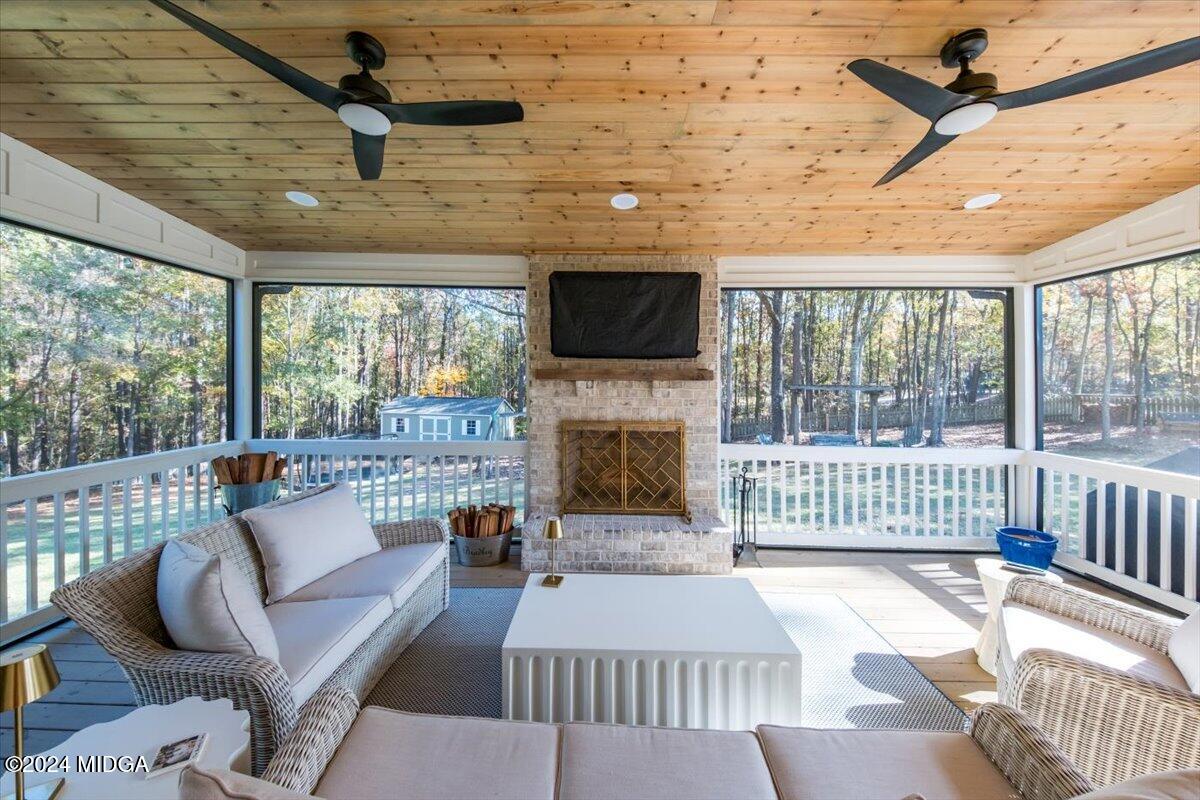 7701 Whittle Road Macon, GA 31220 - Photo 40 of 56 a living room with furniture a flat screen tv and a fireplace