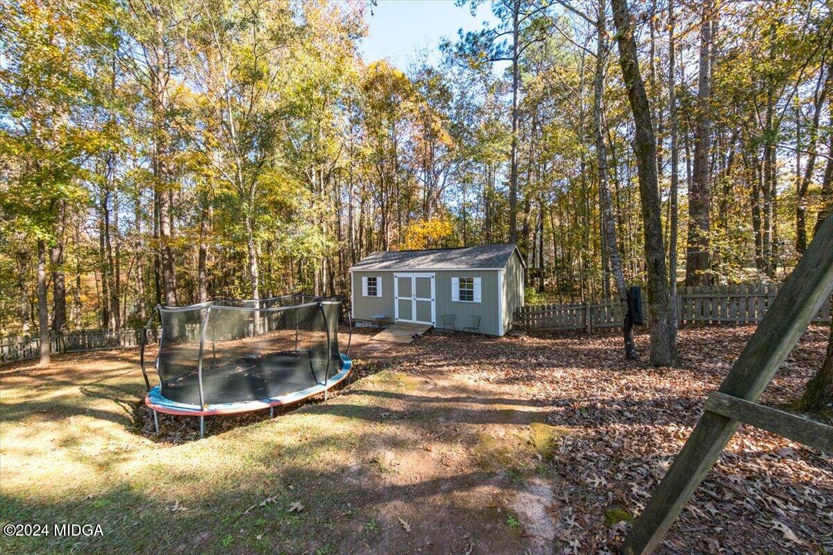 7701 Whittle Road Macon, GA 31220 - Photo 48 of 56 a view of a house with backyard and trees