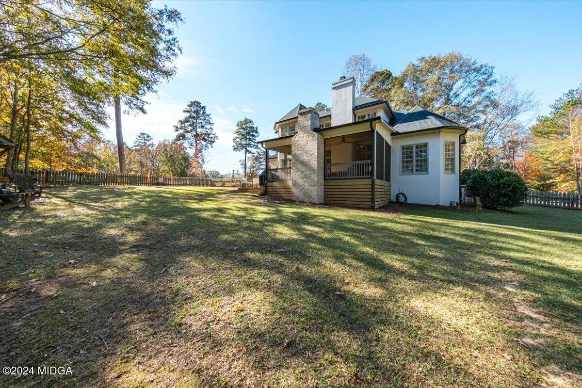 7701 Whittle Road Macon, GA 31220 - Photo 49 of 56 a view of a big house with a big yard and large trees