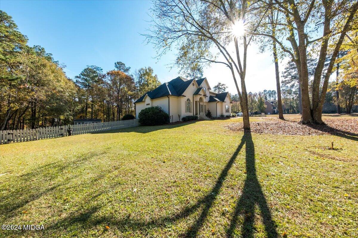 7701 Whittle Road Macon, GA 31220 - Photo 54 of 56 a view of swimming pool with large trees and wooden fence