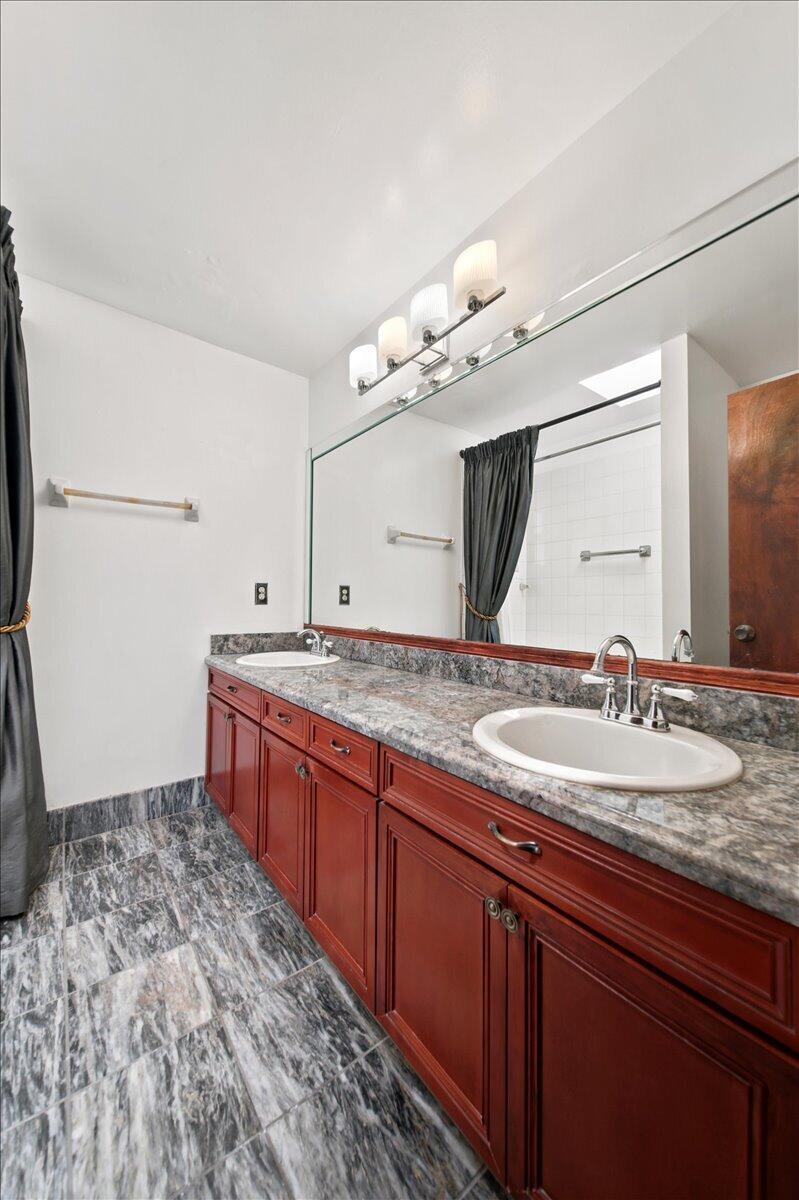 20009 Northwest 66th Place Hialeah, FL 33015 - Photo 22 of 33 a bathroom with a sink and a mirror