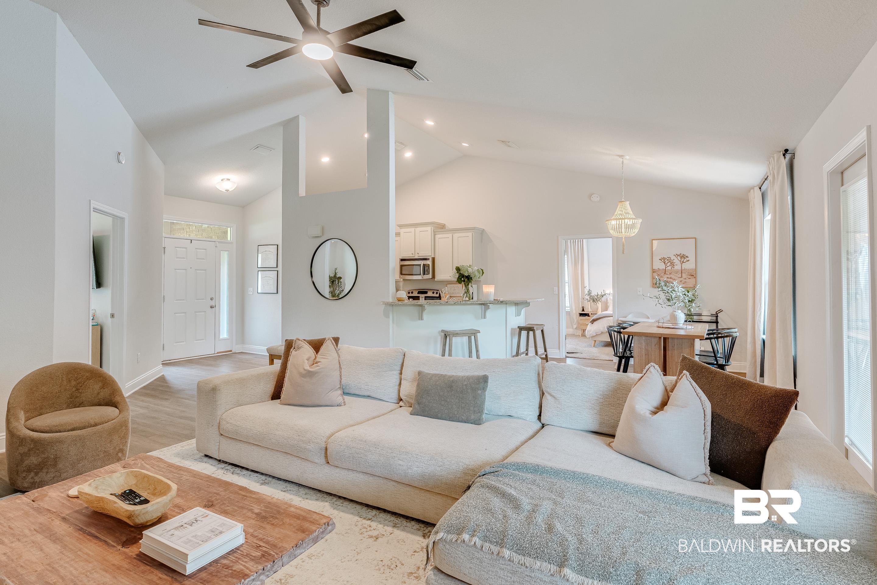 2215 Fernwood Loop West Semmes, AL 36575 - Photo 3 of 40 Vaulted ceilings highlighting an open-concept layout with wood-finish flooring