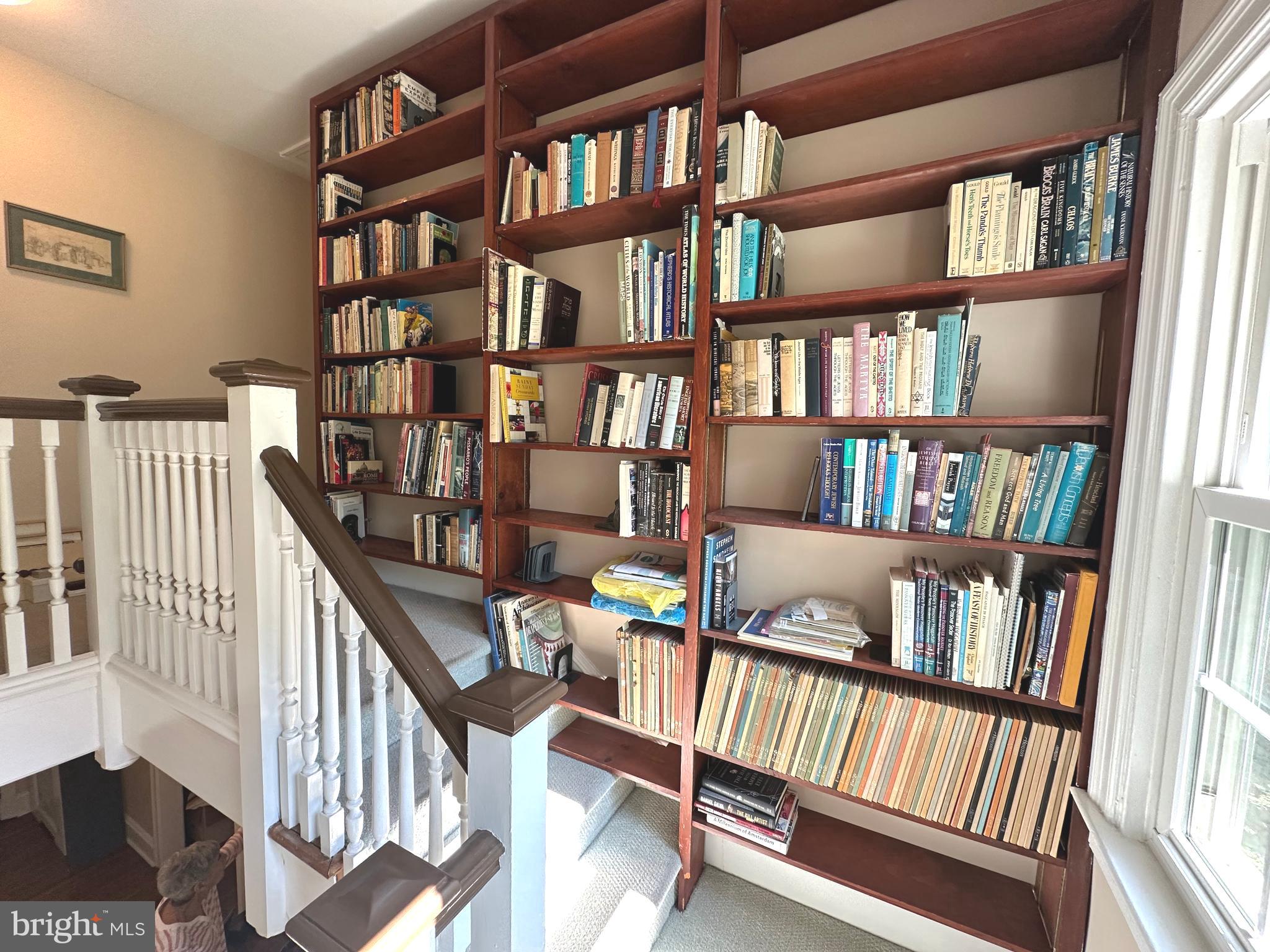 352 Calvert Road Merion Station, PA 19066 - Photo 15 of 40 Winding stairwell with loads of book shelves