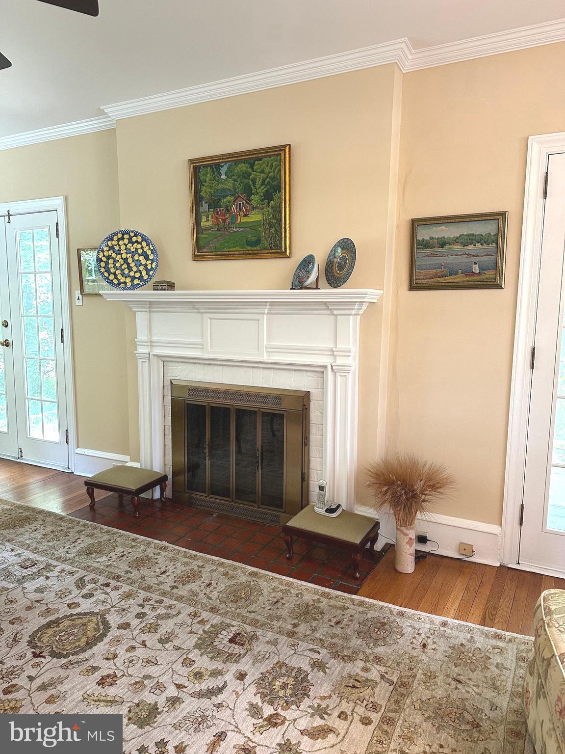 Fireplace flanked by French doors to  porch