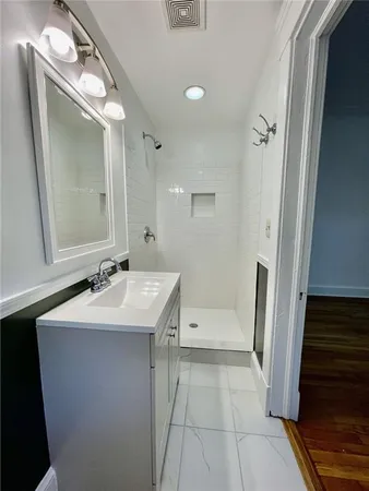 a bathroom with a sink a toilet a mirror and vanity
