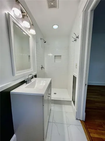 a bathroom with a sink a toilet a mirror and vanity