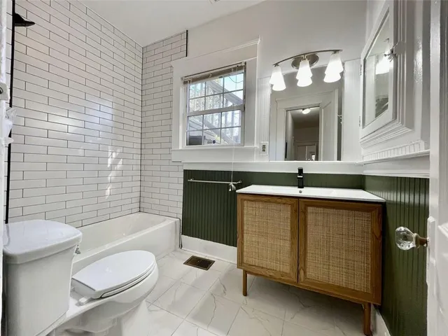 a bathroom with a sink a toilet and bathtub