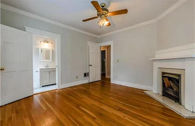 a view of an empty room with a fireplace and a window