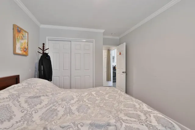 a bedroom with a bed and a painting on the wall