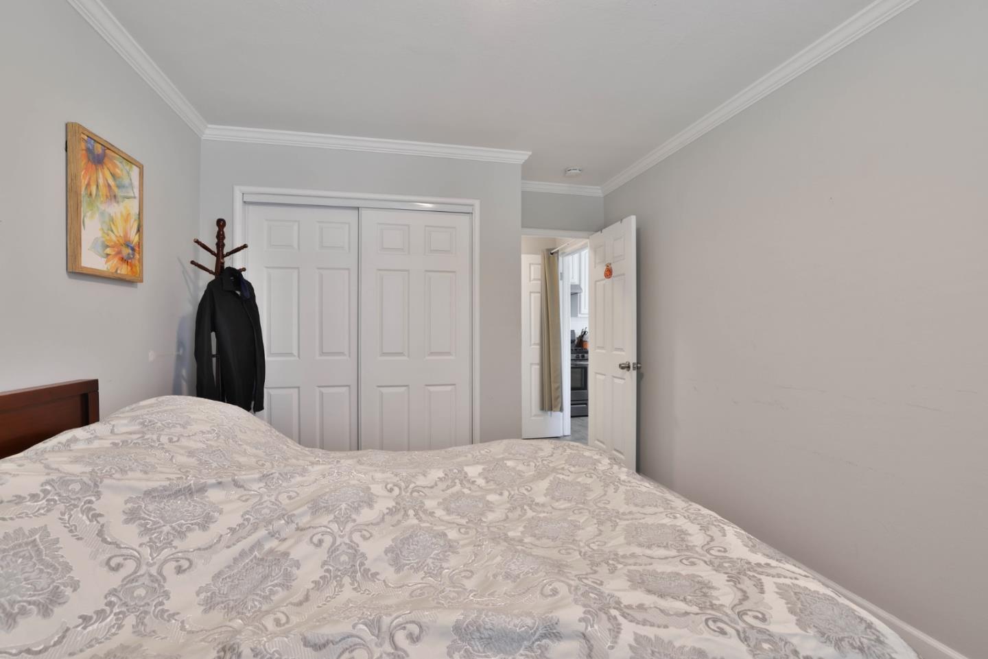 1431 Dwight Way Berkeley, CA 94702 - Photo 15 of 21 a bedroom with a bed and a painting on the wall