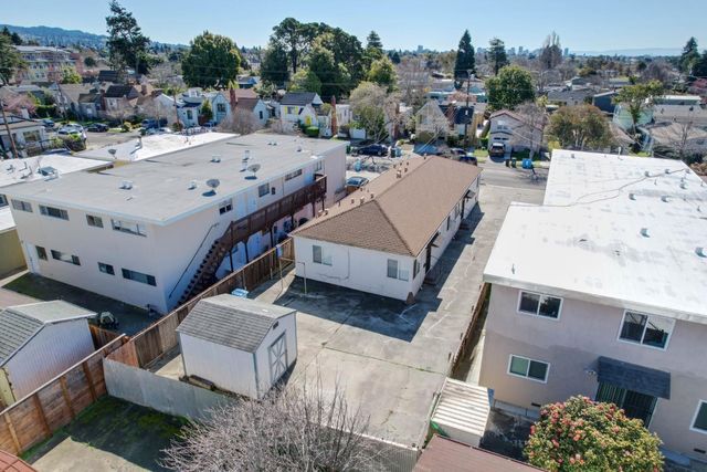 an aerial view of a house with a yard and furniture