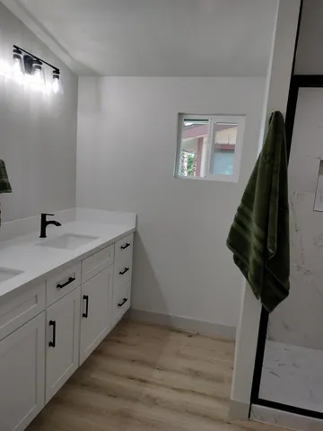 a bathroom with a double vanity sink and mirror