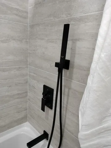 a bathroom with a shower and a bath tub