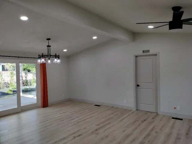 a view of an empty room and wooden floor