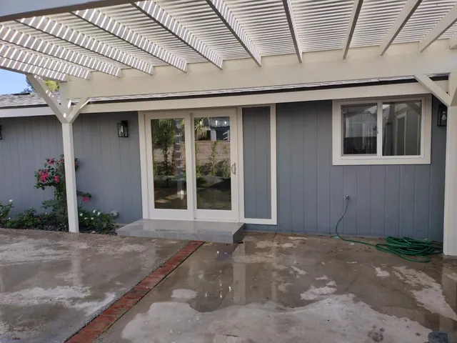 a front view of a house with a yard and garden