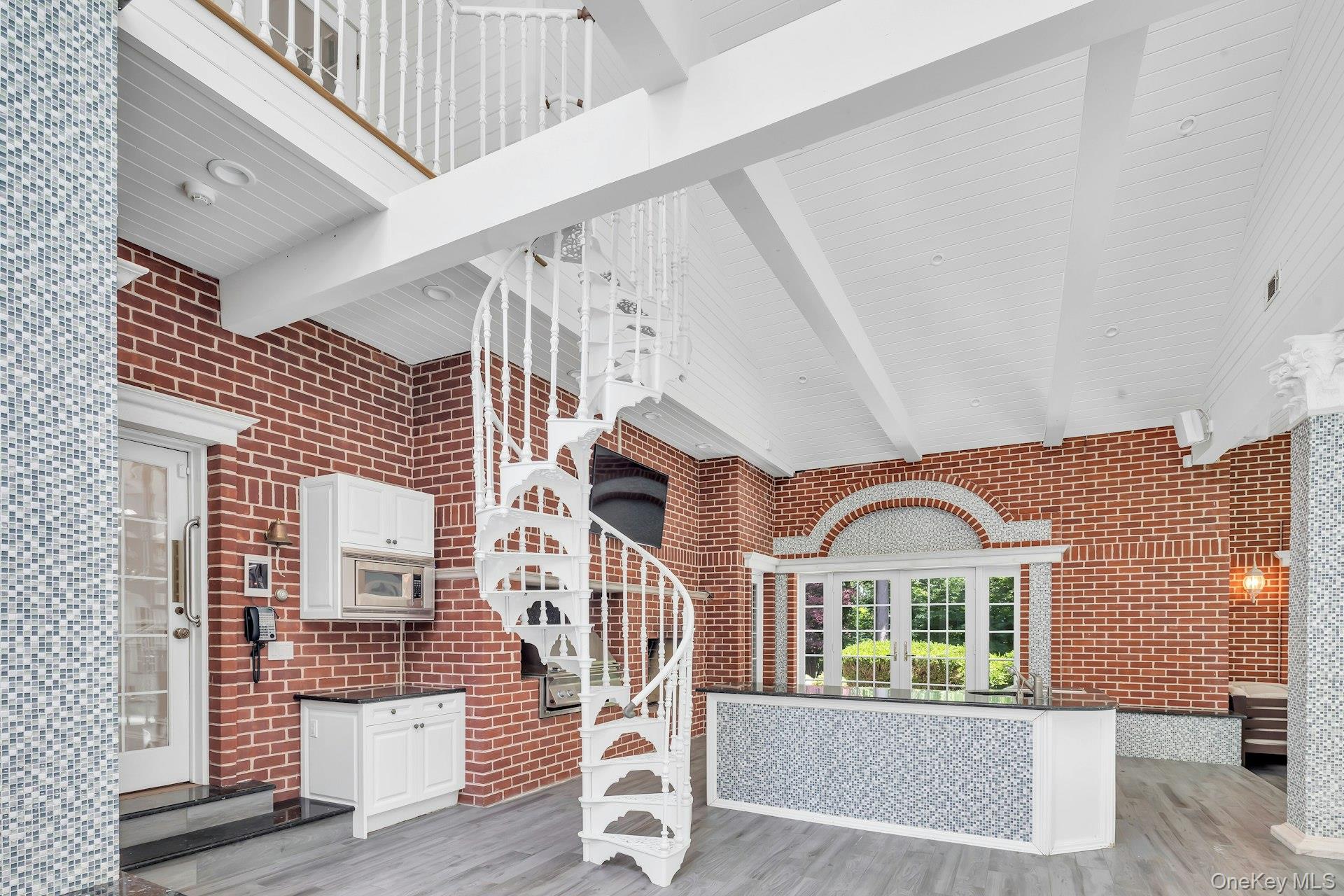 98 Cliff Road Port Jefferson, NY 11777 - Photo 21 of 47 Spiral Staircase in Sunroom/In Door Pool, to Primary Suite
