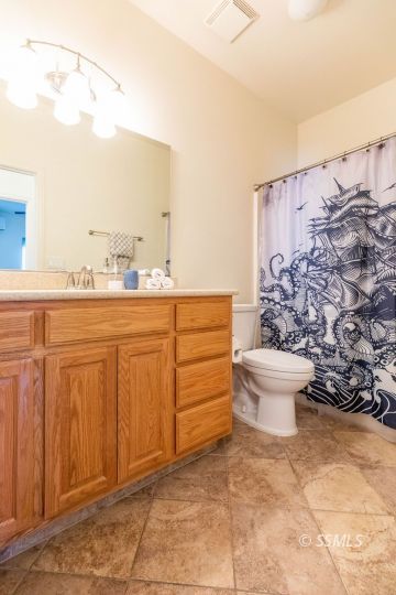 409 Acacia Street Ridgecrest, CA 93555 - Photo 29 of 34 a bathroom with a toilet a sink and a shower