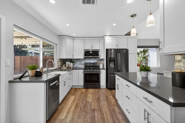 a kitchen with granite countertop stainless steel appliances and counter space