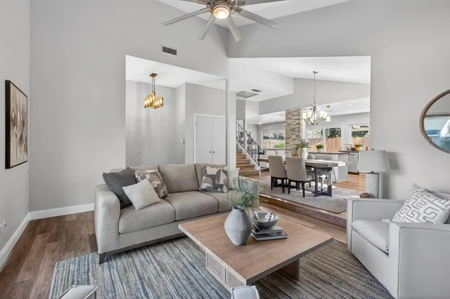 a living room with furniture and wooden floor