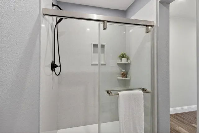 a view of empty room with window and ceiling fan