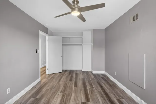 a bathroom with a granite countertop toilet sink and mirror