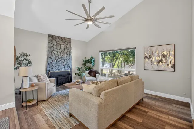 a living room with furniture and a chandelier
