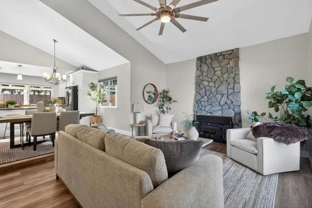 a living room with furniture a fireplace and a large window