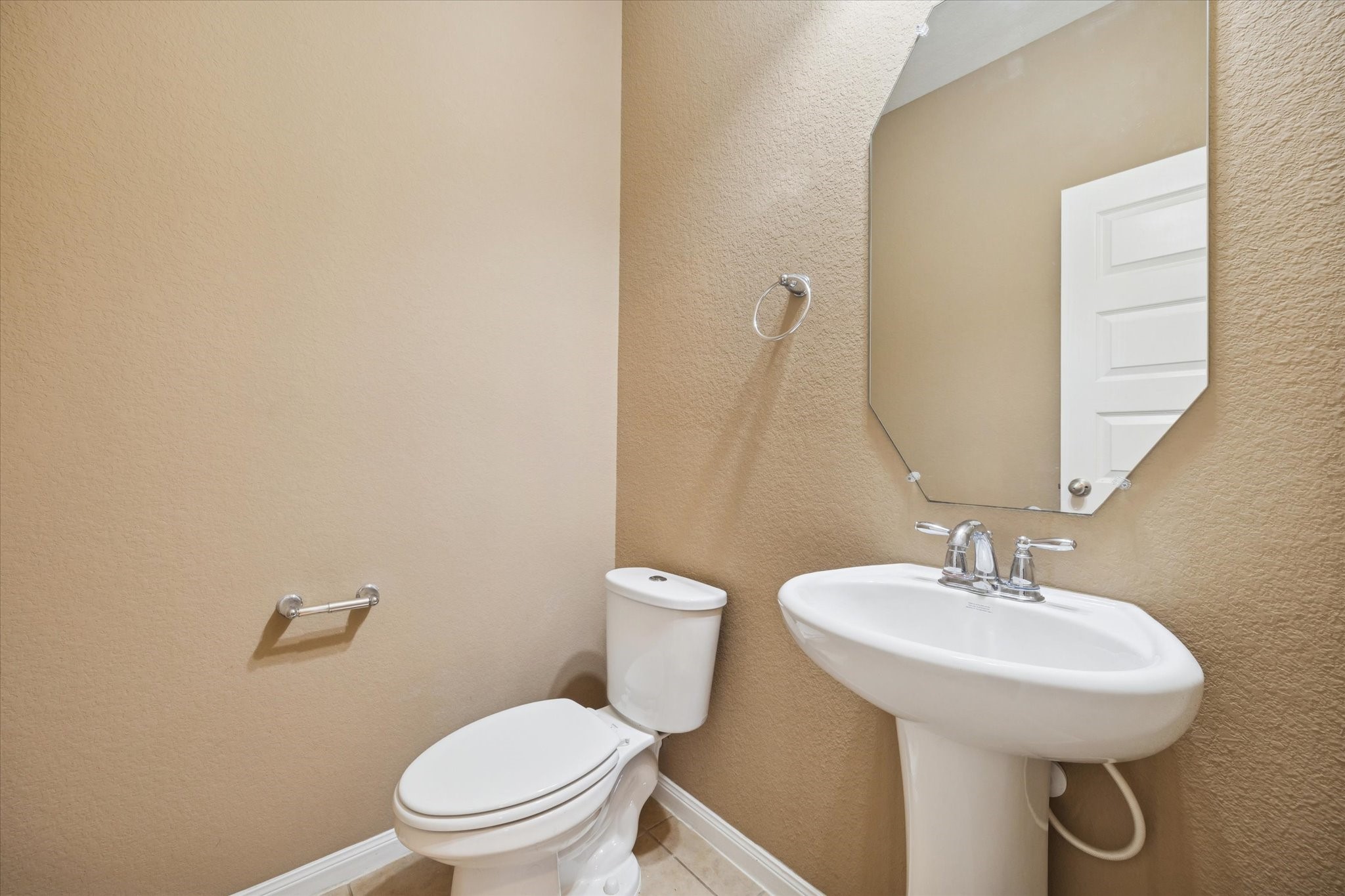 7023 Sliding Rock Circle Spring, TX 77379 - Photo 15 of 39 a bathroom with a toilet a sink and mirror