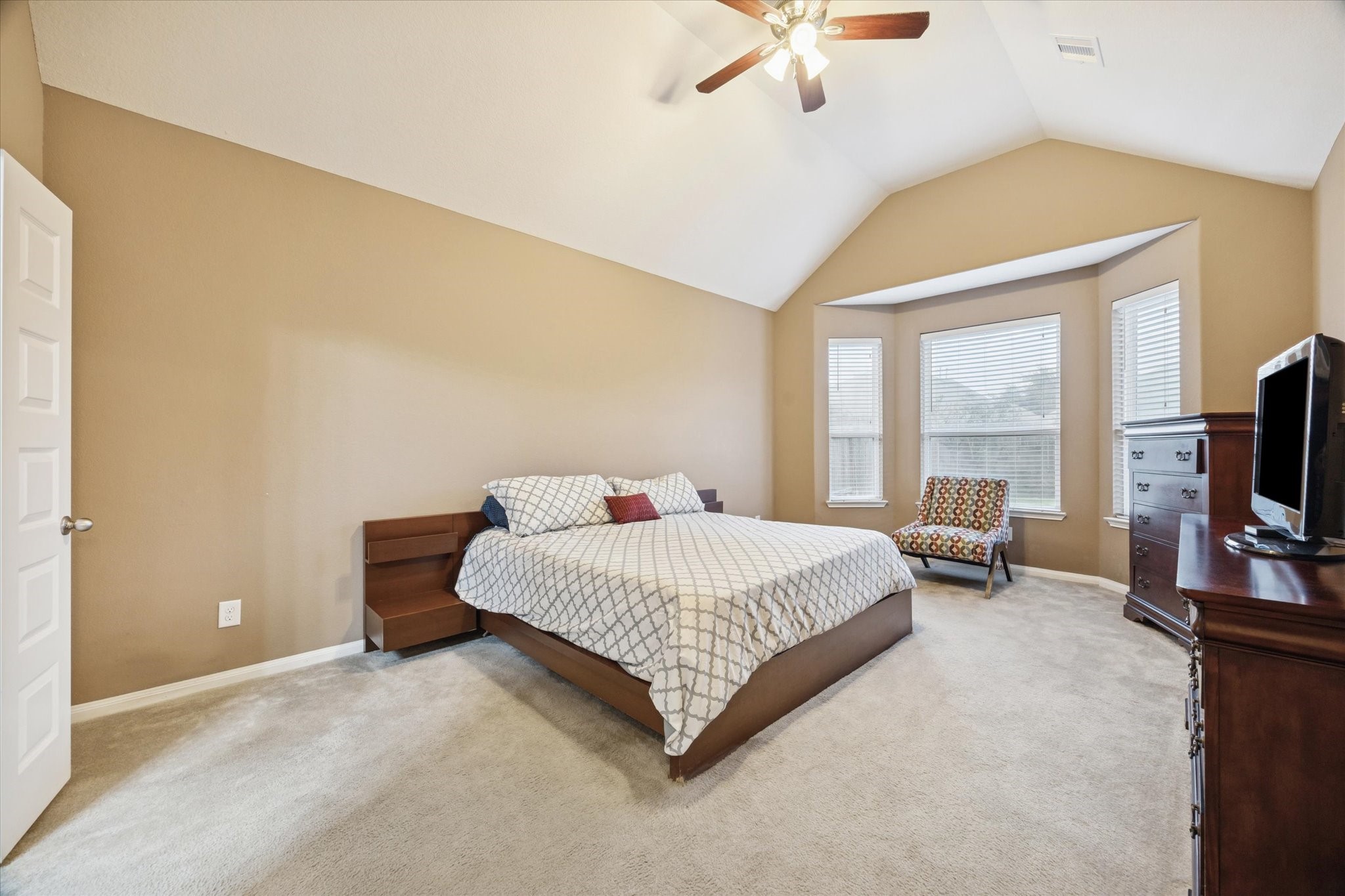 7023 Sliding Rock Circle Spring, TX 77379 - Photo 16 of 39 a bedroom with a bed and a flat tv screen on dresser