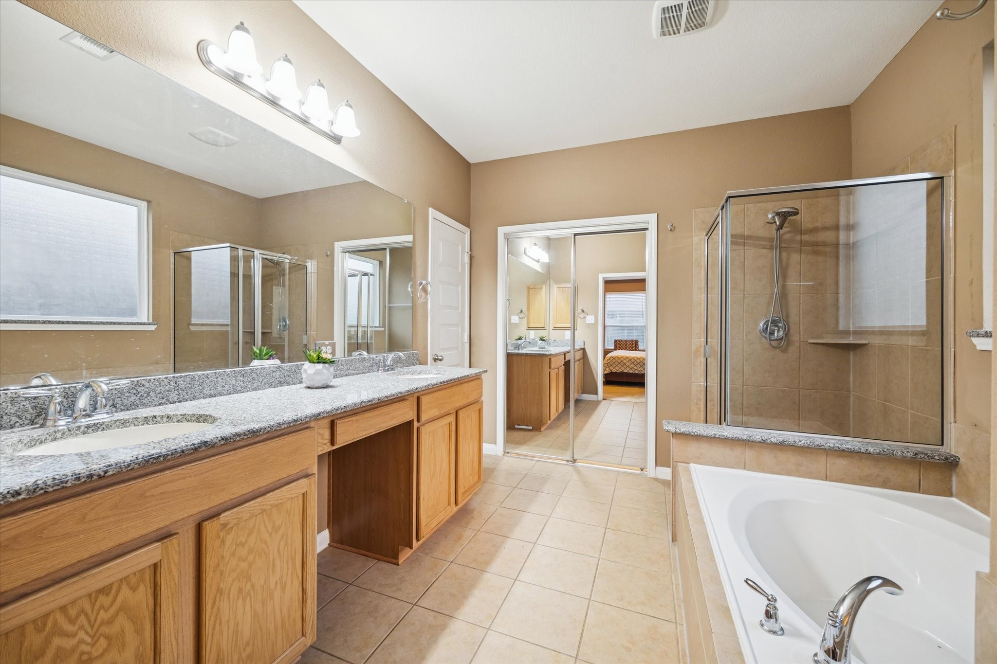 7023 Sliding Rock Circle Spring, TX 77379 - Photo 18 of 39 a large bathroom with a granite countertop tub sink shower and mirror