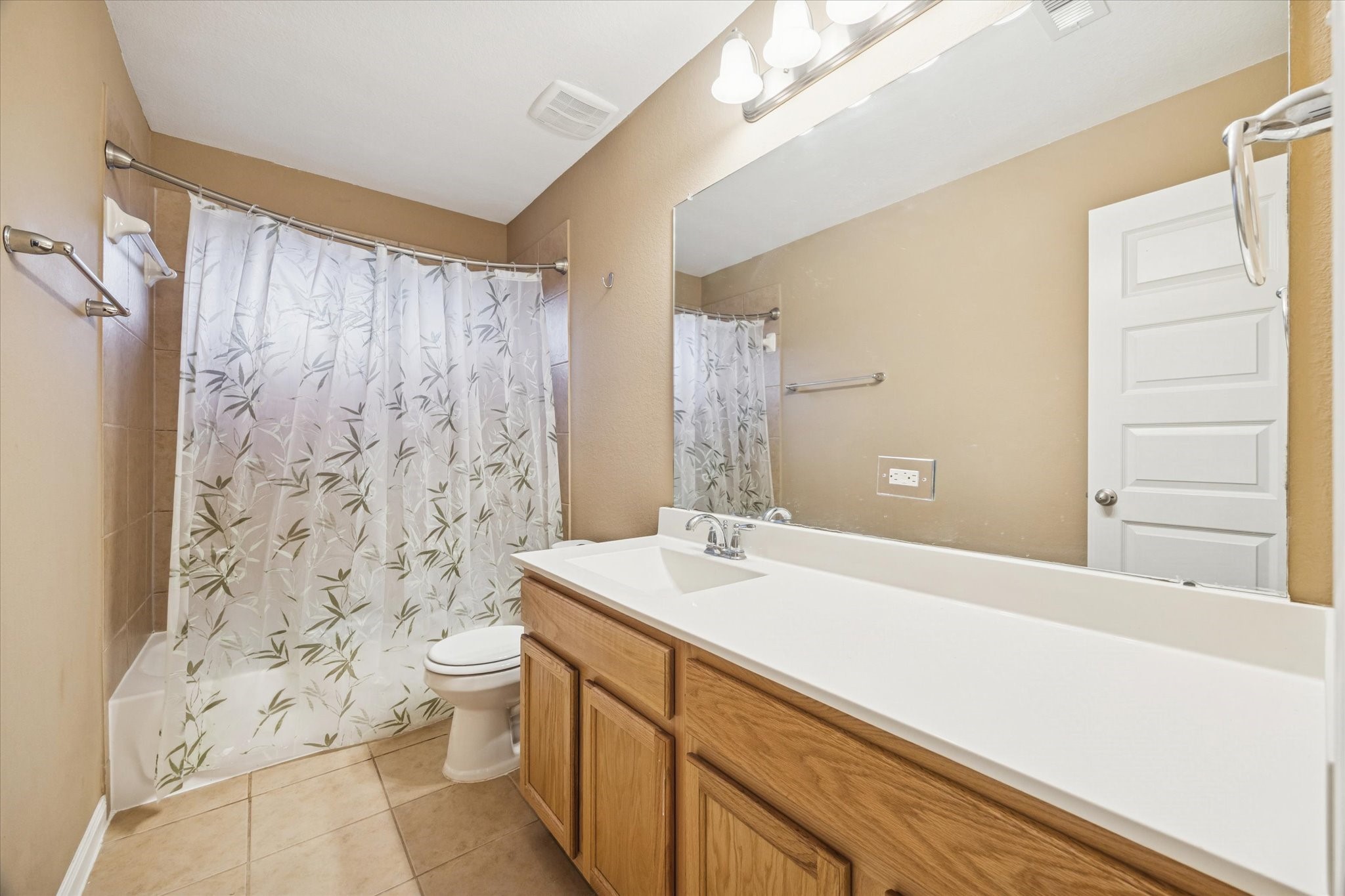 7023 Sliding Rock Circle Spring, TX 77379 - Photo 25 of 39 a bathroom with a sink a toilet and shower curtain