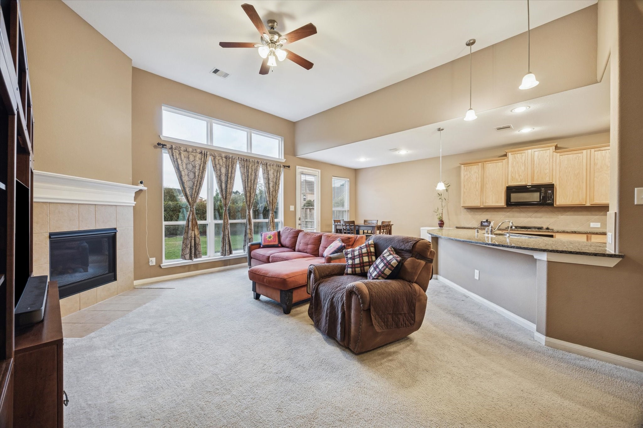 7023 Sliding Rock Circle Spring, TX 77379 - Photo 9 of 39 a living room with furniture a fireplace and a flat screen tv