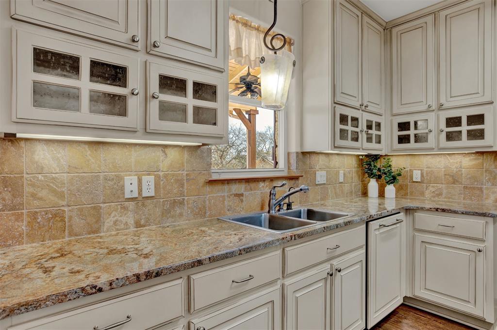 5255 Lookout Ridge Drive Marble Falls, TX 78654 - Photo 23 of 40 Granite counters and country cabinets with glass panels and tile back splash