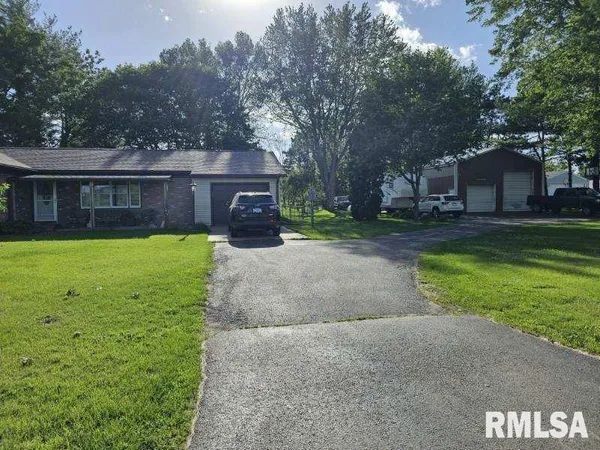 a view of a house with a yard and sitting area