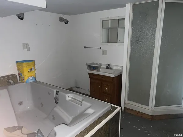 a bathroom with a tub sink and toilet