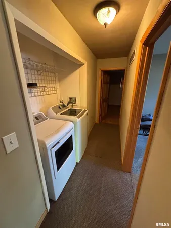 a view of a kitchen with a sink washer and dryer