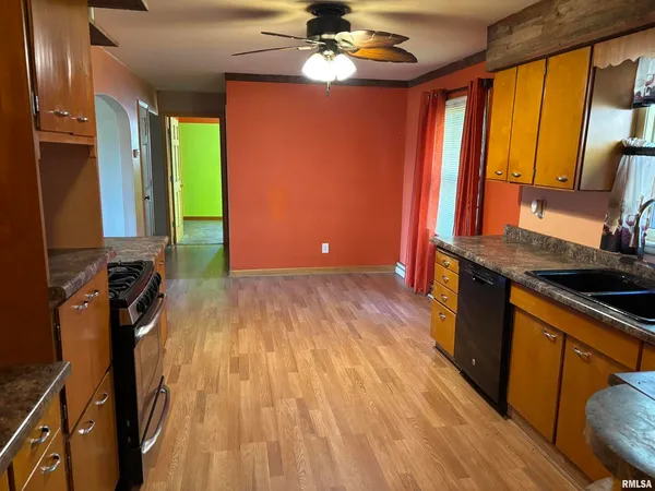 a kitchen with a sink appliances and cabinets