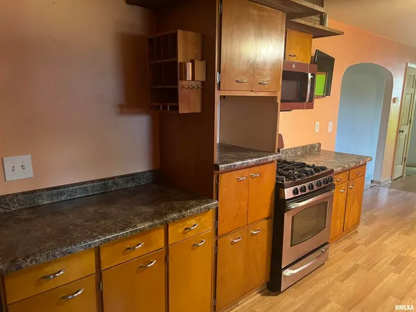 a kitchen with granite countertop stainless steel appliances and wooden cabinets