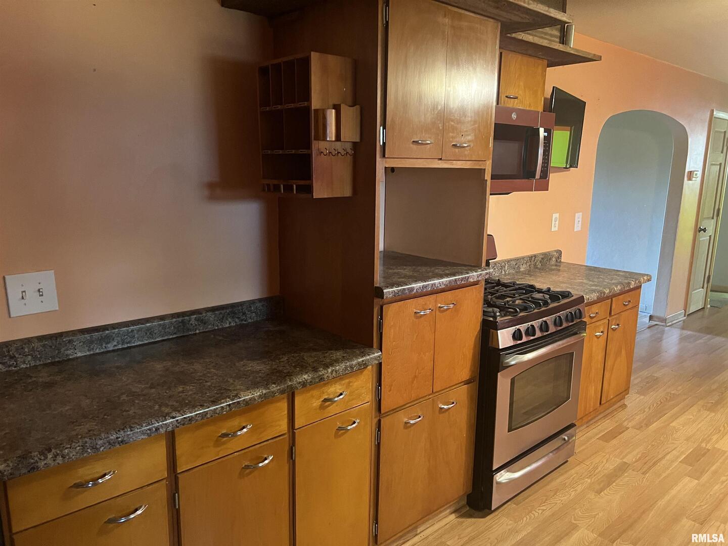 3638-84 84th Thomson, IL 61285 - Photo 6 of 43 a kitchen with granite countertop stainless steel appliances and wooden cabinets