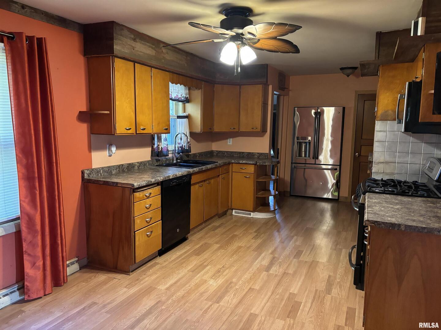 3638-84 84th Thomson, IL 61285 - Photo 7 of 43 a kitchen with stainless steel appliances granite countertop a refrigerator a sink dishwasher a stove and a dining table with wooden floor
