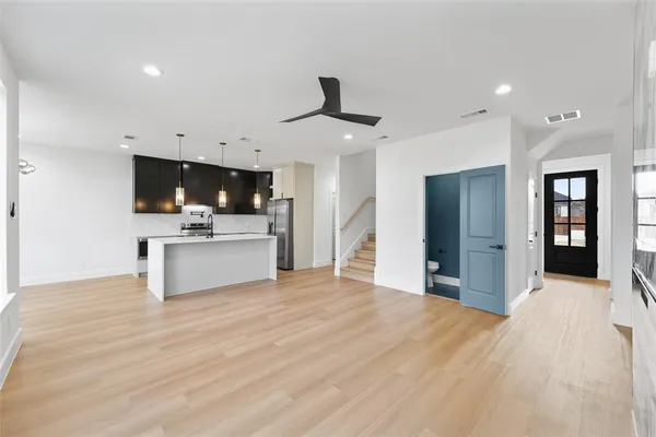 an empty room with windows and chandelier