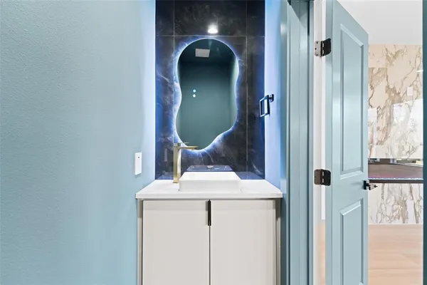 a bathroom with a granite countertop shower and a toilet
