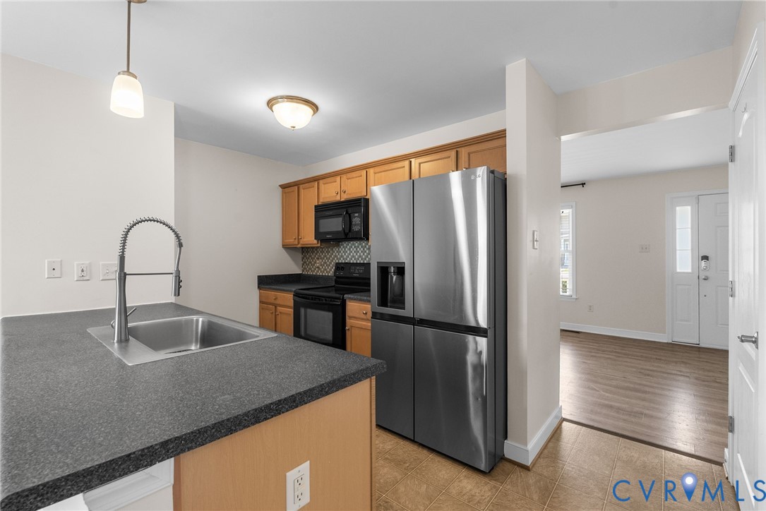 2110 Chaucer Court Aylett, VA 23009 - Photo 15 of 40 a kitchen with granite countertop a refrigerator and a sink