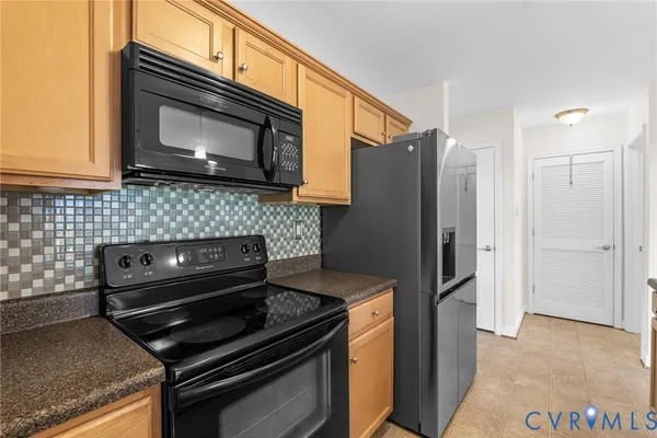 a kitchen with a stove microwave and refrigerator