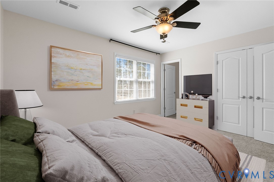 2110 Chaucer Court Aylett, VA 23009 - Photo 26 of 40 a bedroom with a bed a window and a flat screen tv
