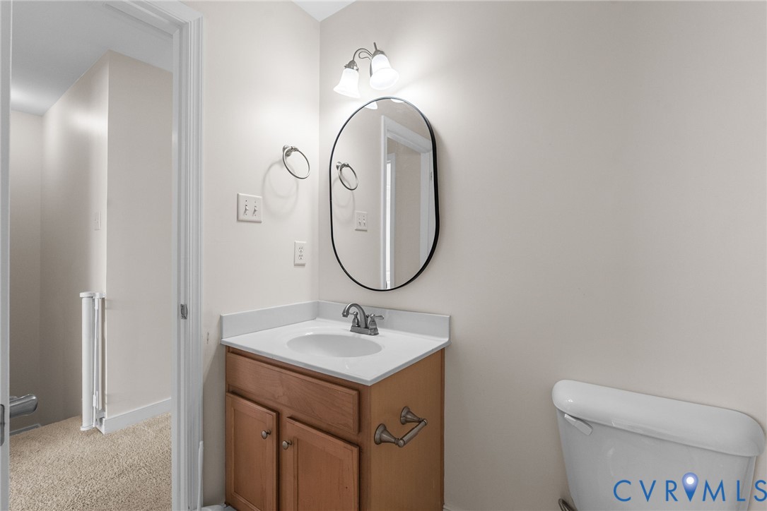 2110 Chaucer Court Aylett, VA 23009 - Photo 29 of 40 a bathroom with a sink mirror and toilet